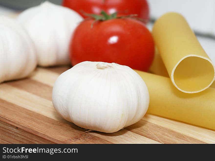 Cannelloni With a tomato and garlic on a chopping board