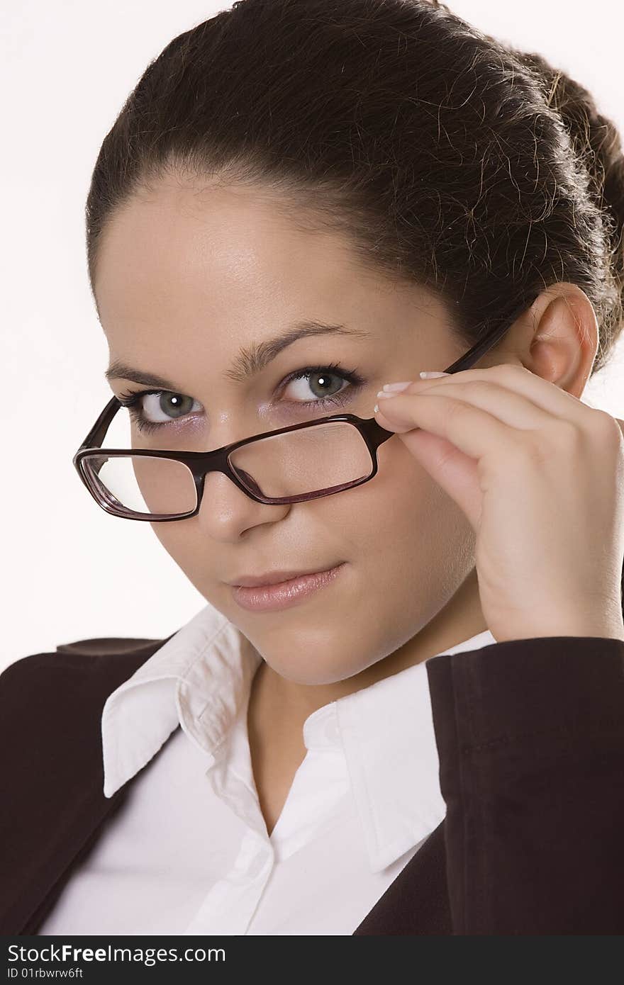 Young woman looking over the top of her glasses. Young woman looking over the top of her glasses