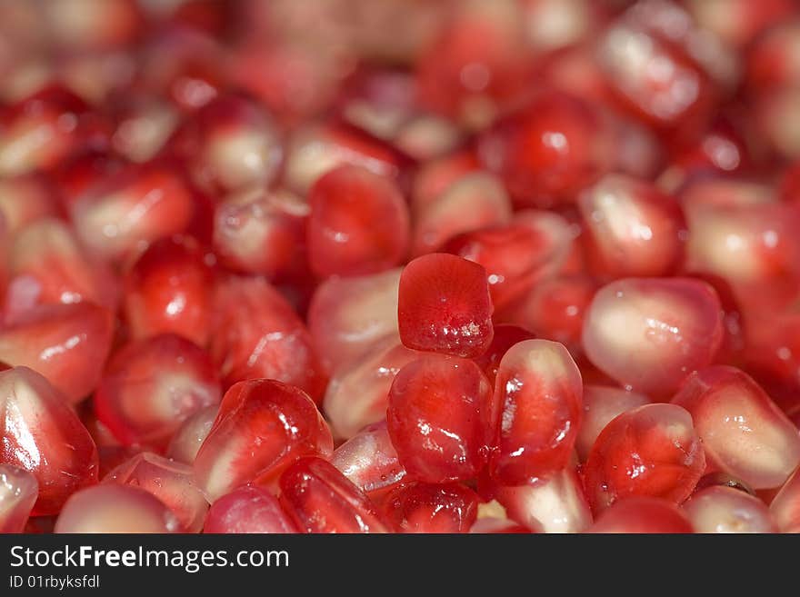 A lot of red ripe pomegranat corns. A lot of red ripe pomegranat corns