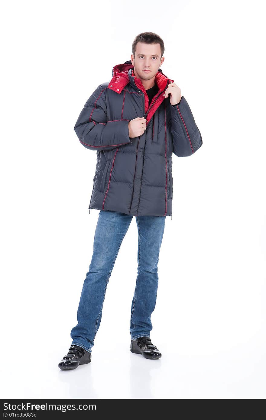 Young man in winter warm down jacket on isolated background. Young man in winter warm down jacket on isolated background