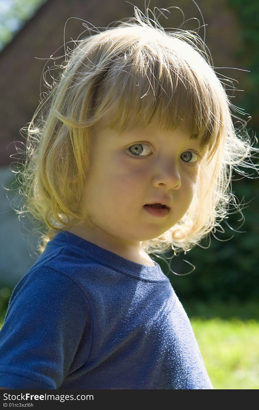 Outdoor portrait of a beautiful boy with long blond hair. Outdoor portrait of a beautiful boy with long blond hair