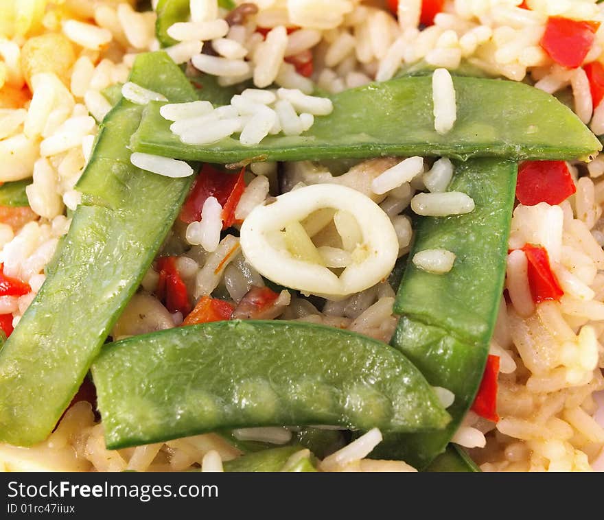 The paella; rice and vegetables