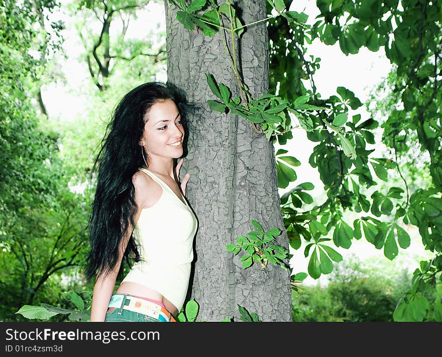 Pretty girl next to a tree in the forest. Pretty girl next to a tree in the forest