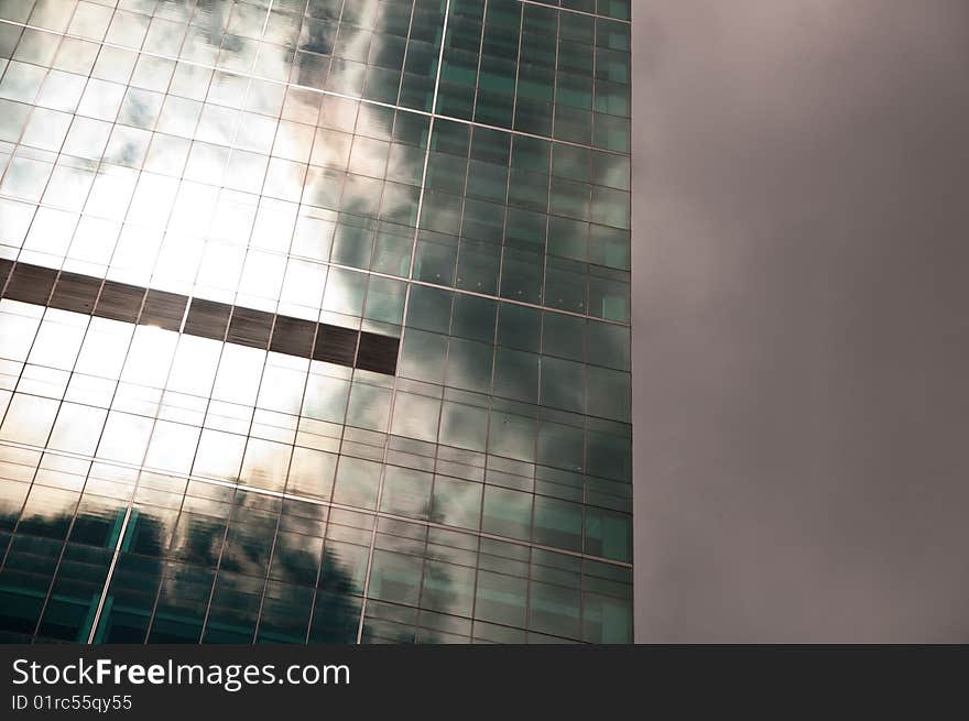 Stormy sky reflected in a modern glass office building. Stormy sky reflected in a modern glass office building