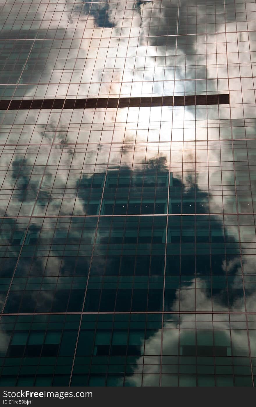 Stormy sky reflected in a modern glass office building. Stormy sky reflected in a modern glass office building