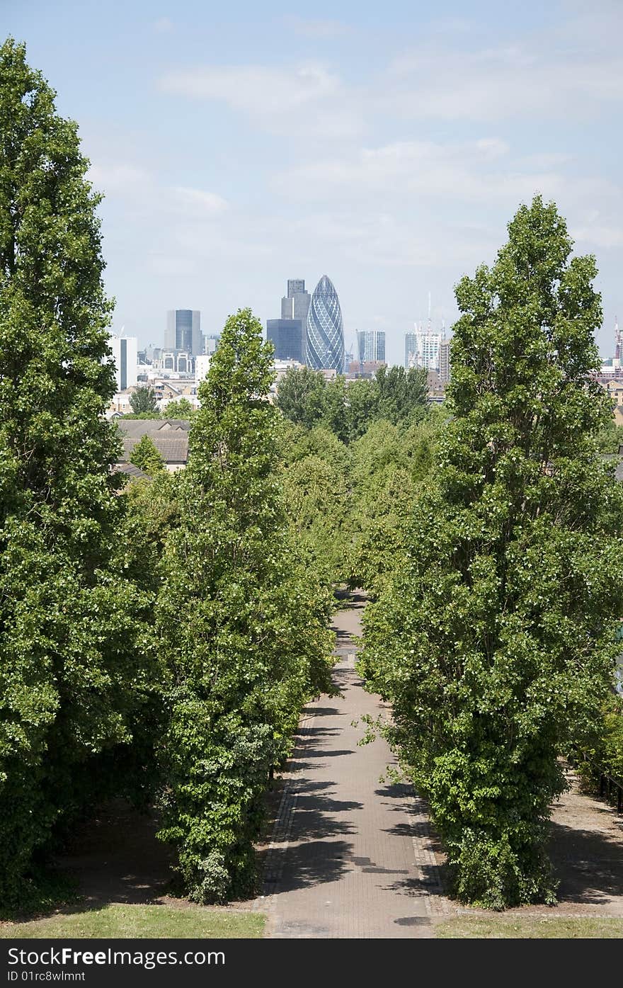 The Gherkin or 20 St Mary Axe seen from Stave Hill in the Eco Park at Surrey Quays London SE16. The Gherkin or 20 St Mary Axe seen from Stave Hill in the Eco Park at Surrey Quays London SE16