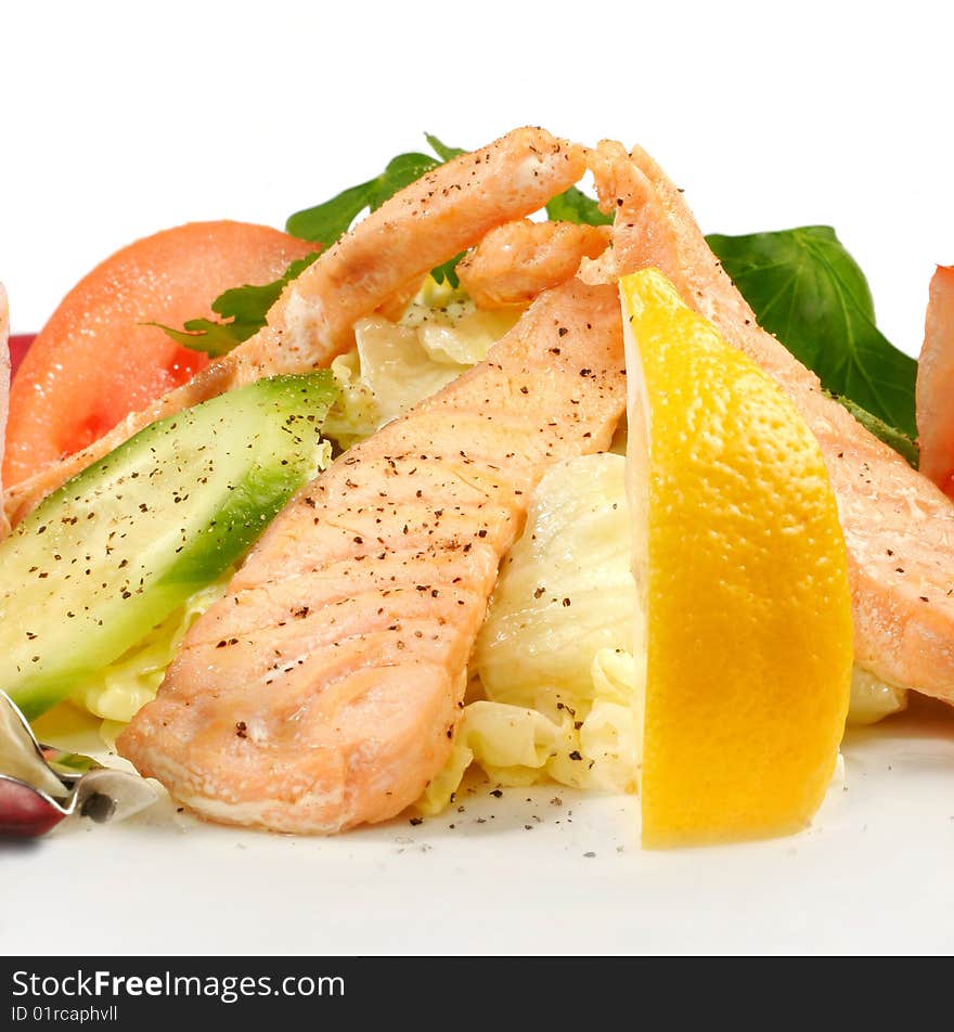 Salmon with vegetables isolated on white. Closeup