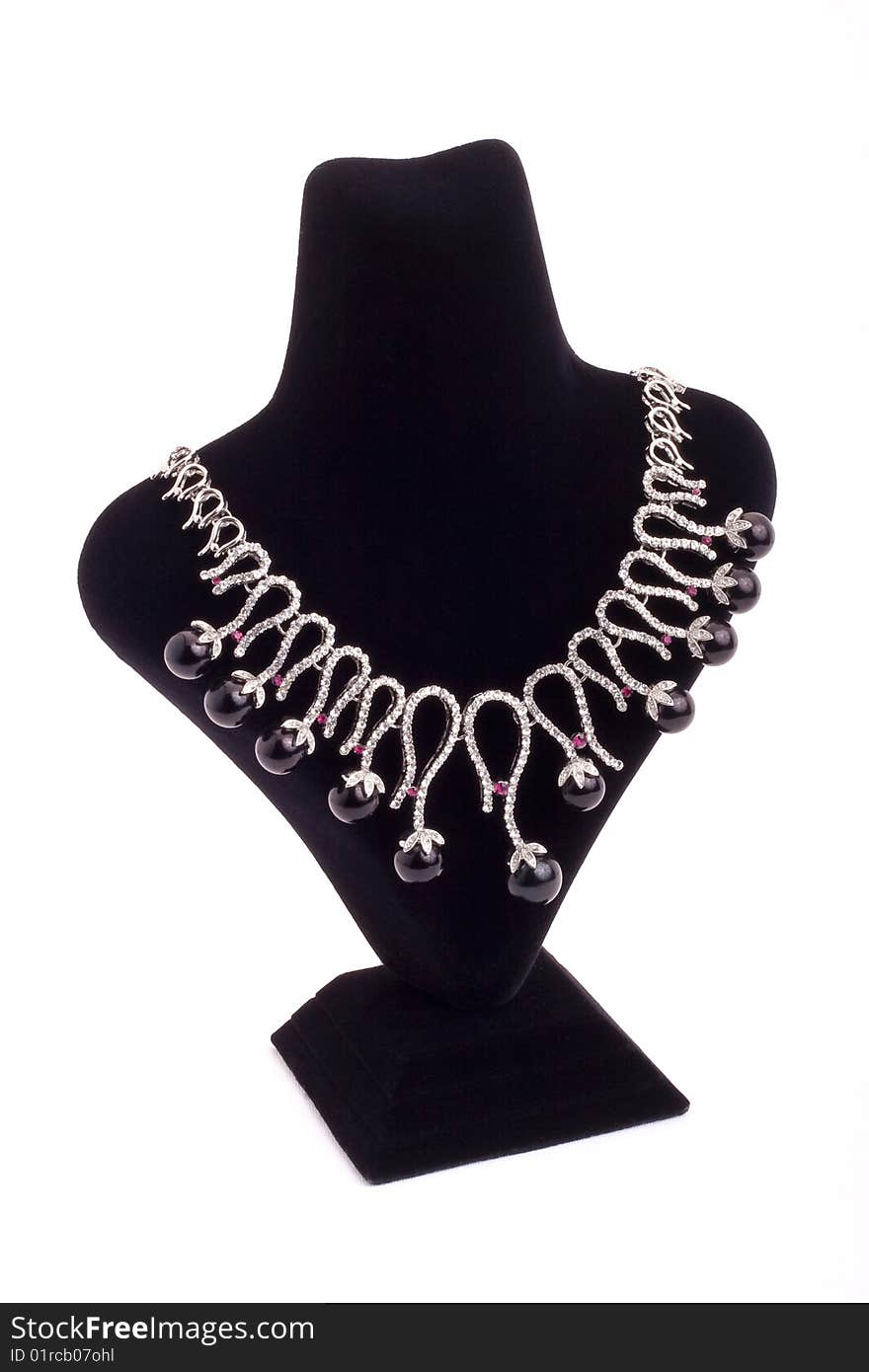 Necklace with black pearls on black stand