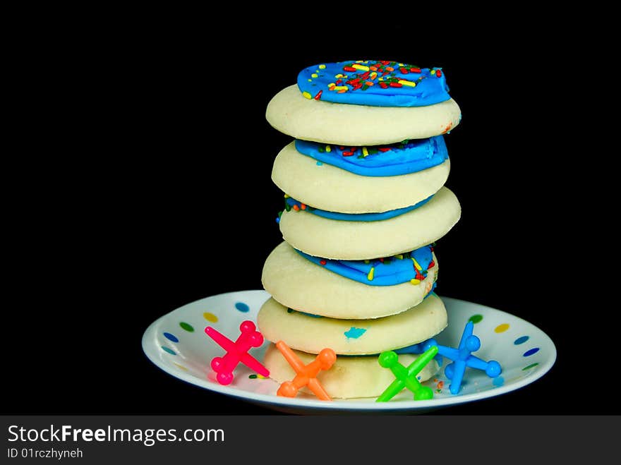 Stack of sugar cookies with toy jacks. Stack of sugar cookies with toy jacks.