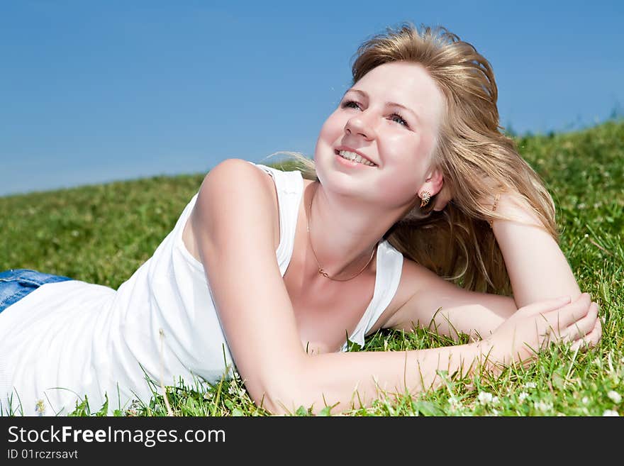 Girl have a rest on a green grass