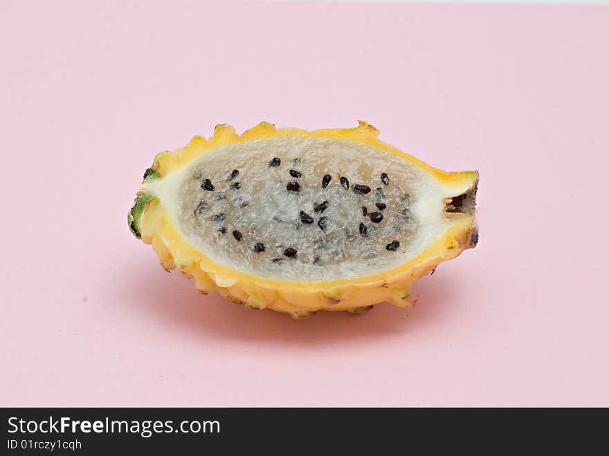 Yellow dragon fruit  section isolated on pink background