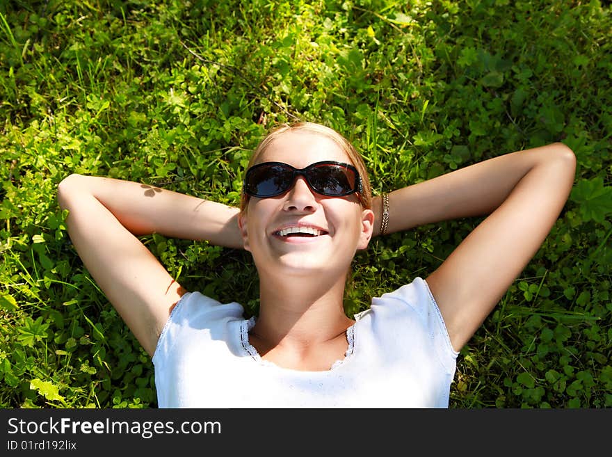 Beautiful girl lying down of grass