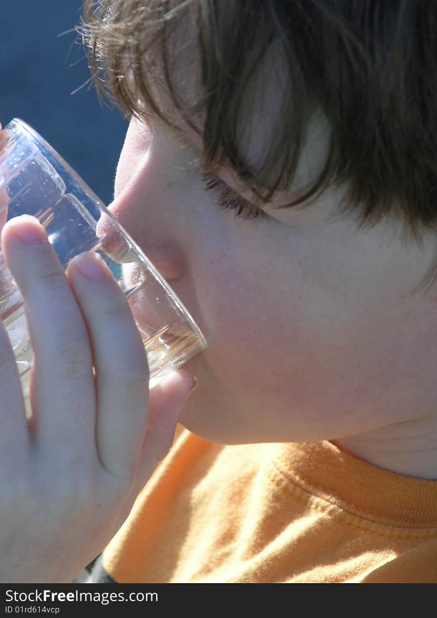 Boy drinking in the sunlight.