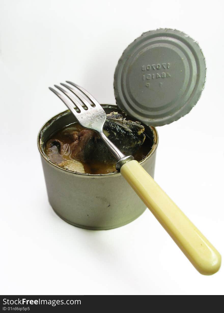 Tourist's breakfast â€” fish, fork & opened tin can. The fork with bone handle incumbent on an opened tin can which is filled with canned fish. All this situated on soft white background. Tourist's breakfast â€” fish, fork & opened tin can. The fork with bone handle incumbent on an opened tin can which is filled with canned fish. All this situated on soft white background.