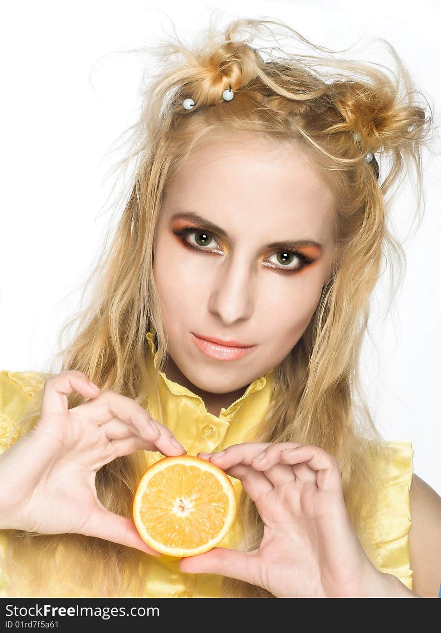 Young girl in yellow dress with piece of orange. Young girl in yellow dress with piece of orange