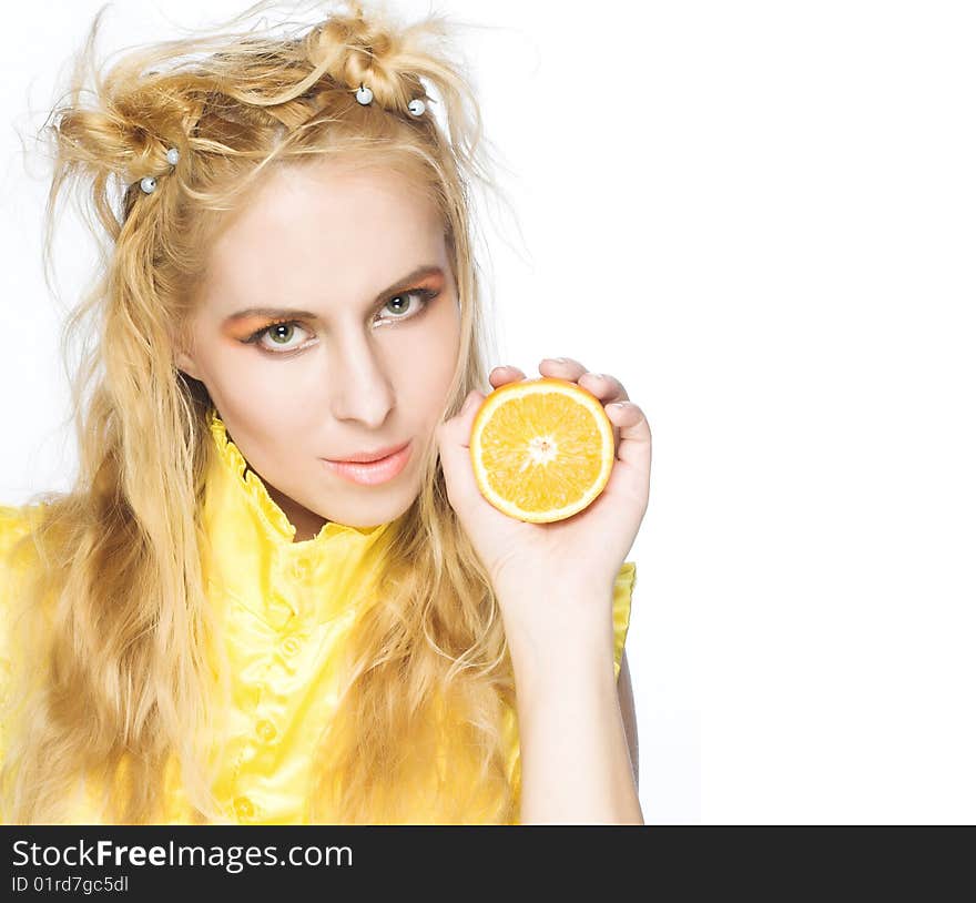 Young girl in yellow dress with piece of orange. Young girl in yellow dress with piece of orange