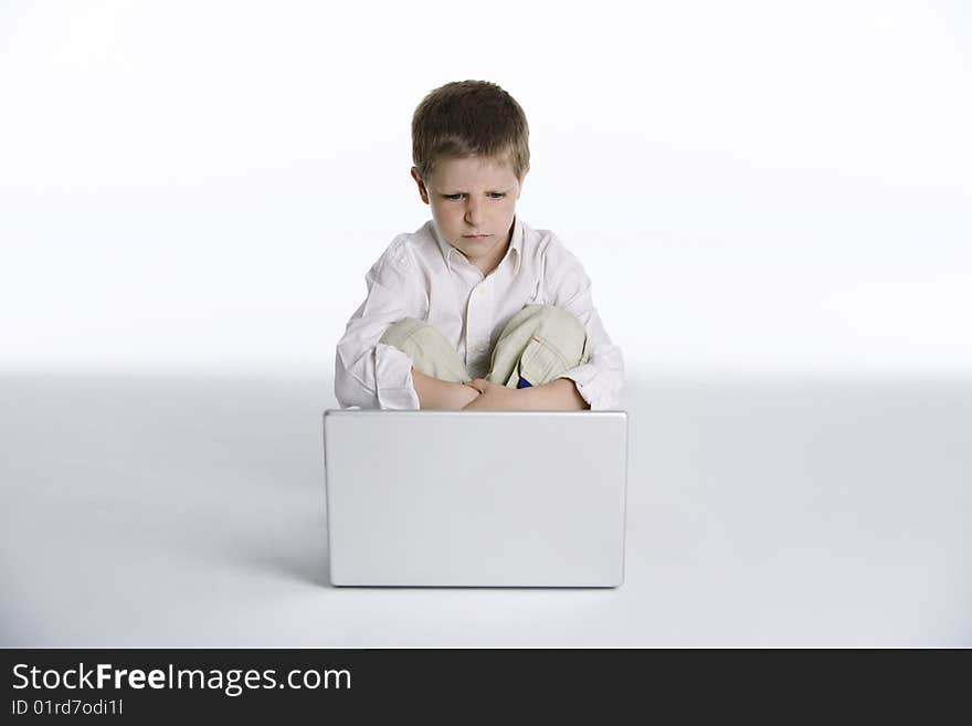 Boy Sitting With A Laptop Computer