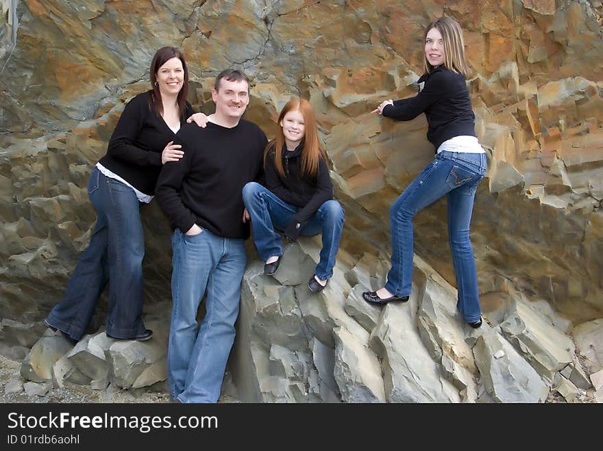 Portrait of parents, tween and teen girls with cliff background that was once an ocean floor. Portrait of parents, tween and teen girls with cliff background that was once an ocean floor