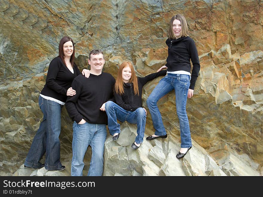 Portrait of parents, tween and teen girls with cliff background that was once an ocean floor. Portrait of parents, tween and teen girls with cliff background that was once an ocean floor