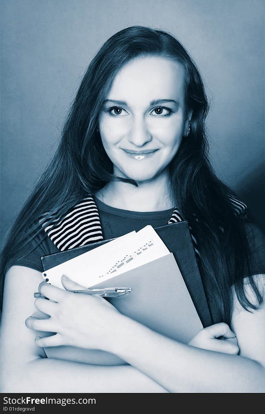 Portrait of student girl with copybooks in her hands.