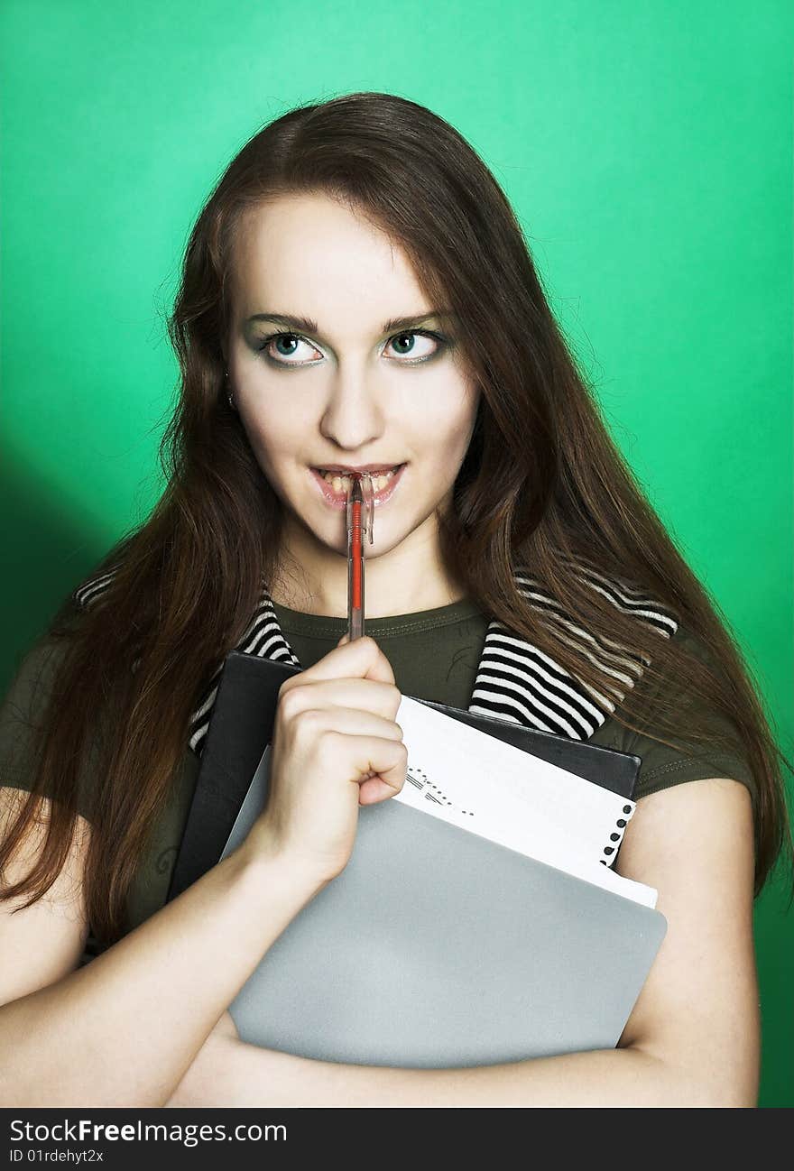 Portrait of student girl with copybooks in her hands.