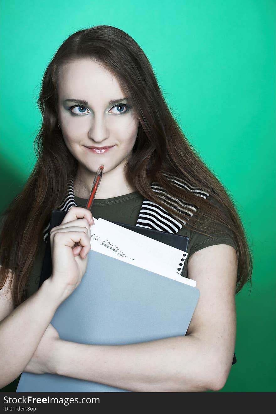 Portrait of student girl with copybooks in her hands.