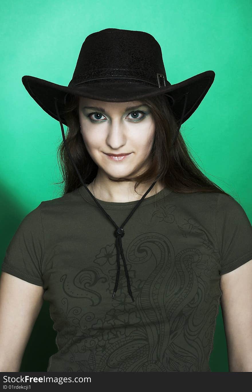 Portrait of young woman in dark cowboy hat. Portrait of young woman in dark cowboy hat