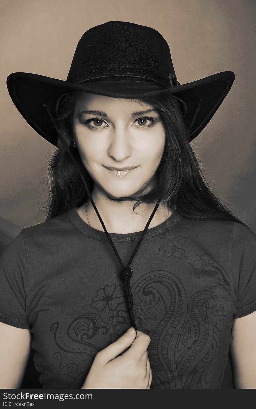 Portrait of young woman in dark cowboy hat. Portrait of young woman in dark cowboy hat