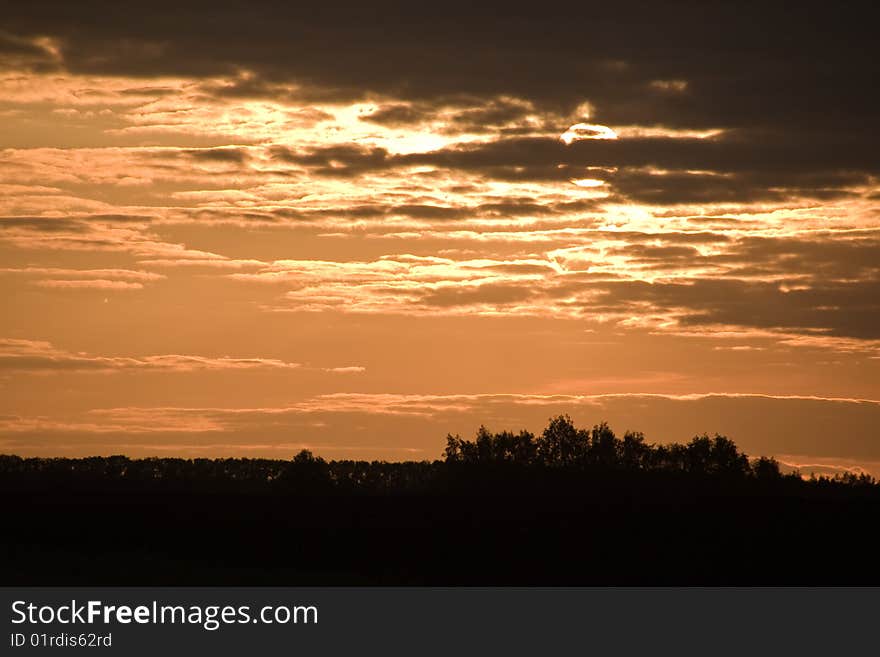 Sunset on cloudy sky.