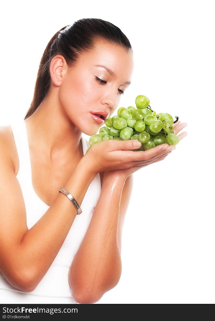 Beautiful young woman with green grape