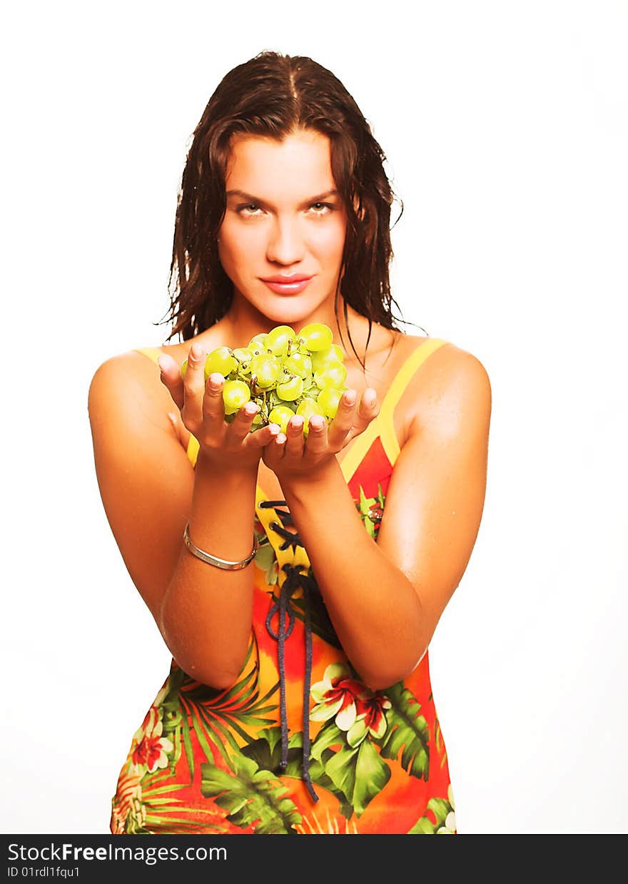 Portrait of young attractive woman with bunch of grapes