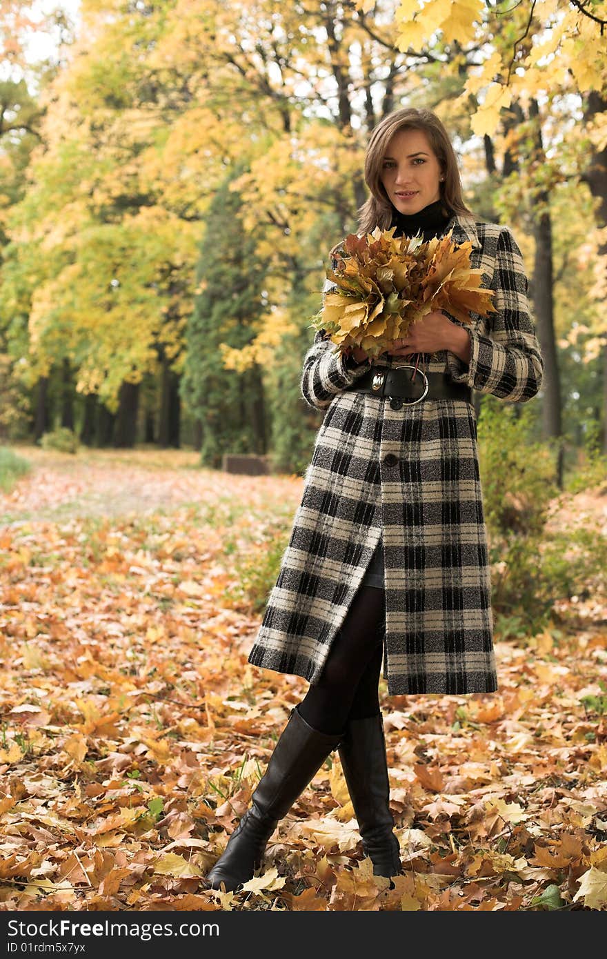 Young woman with a bouquet of maple leaves. Young woman with a bouquet of maple leaves