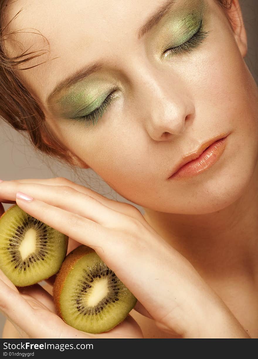 Woman with kiwi on white