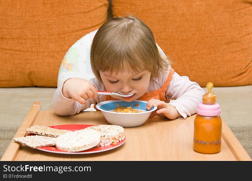 Sweet toddler baby girl eating