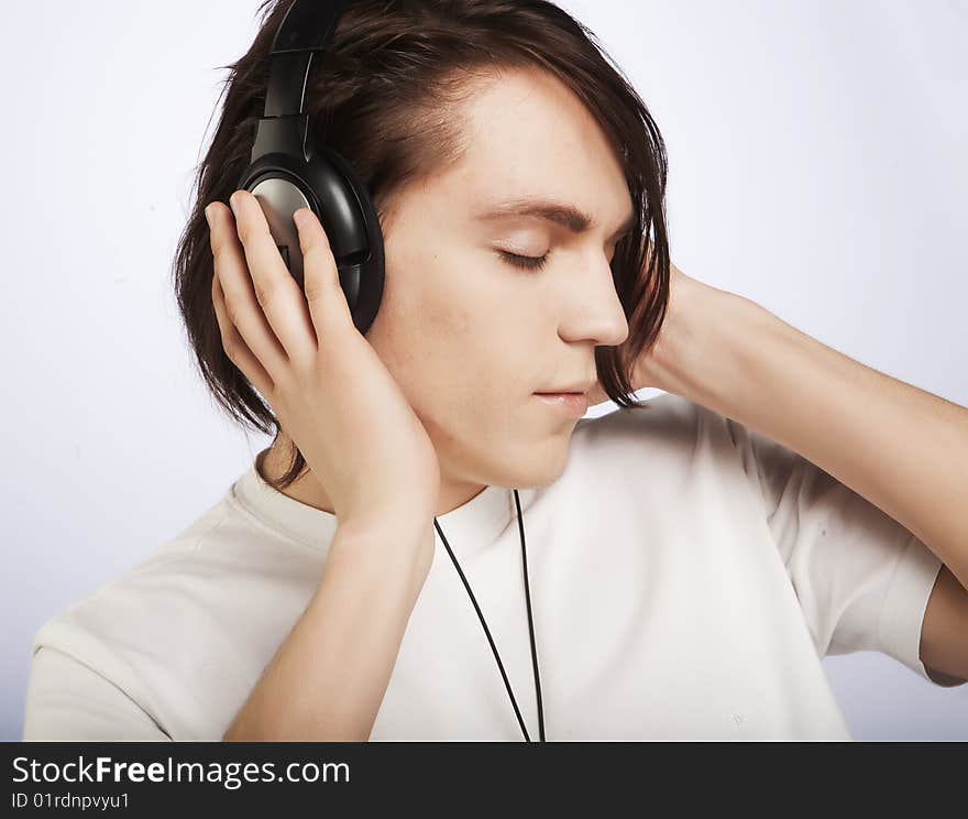 Casual man listening to music, isolated in white background