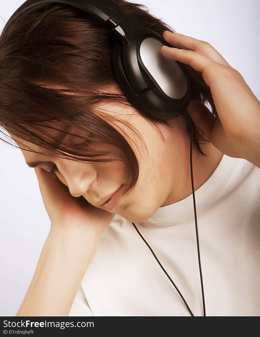 Casual man listening to music, isolated in white background