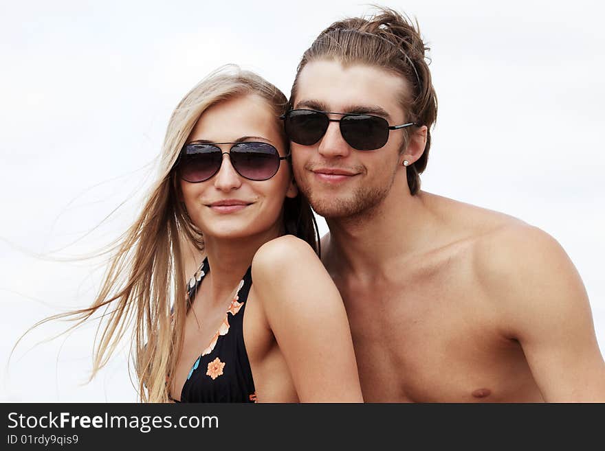 Couple of young people having a rest on a beach. Great summer holidays. Couple of young people having a rest on a beach. Great summer holidays.