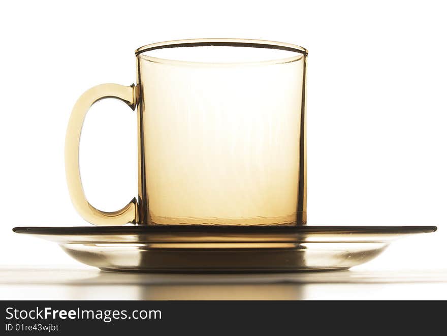 Empty cup and plate brown glass isolated on white. Empty cup and plate brown glass isolated on white