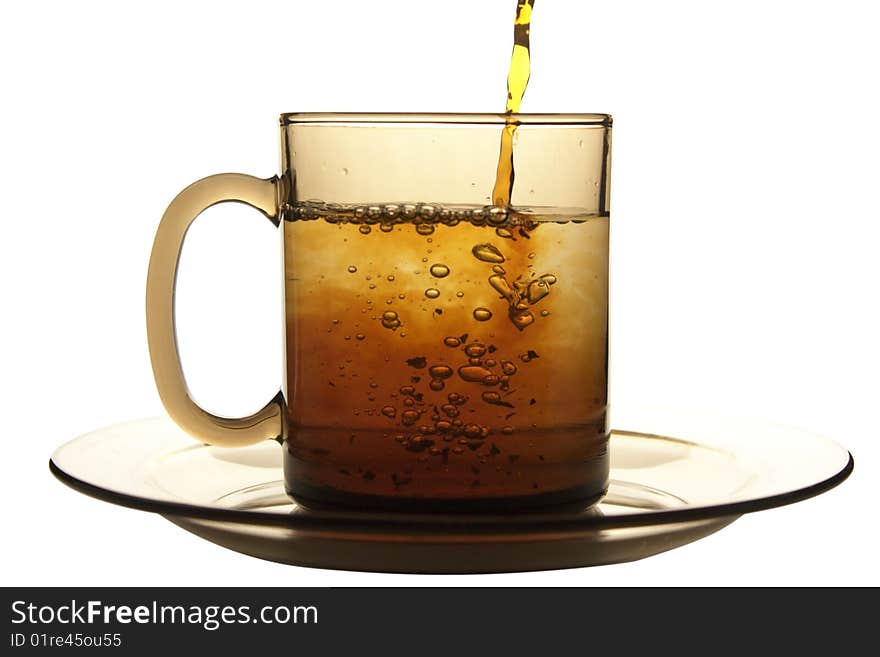 Glass cup of tea  and plate isolated on white