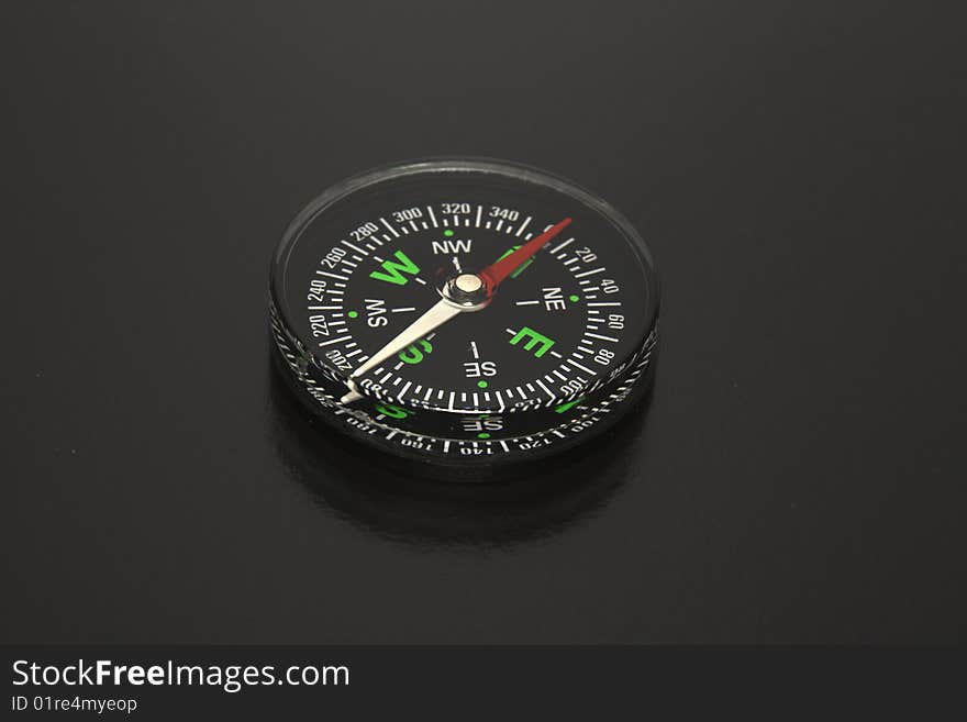 The Black background and traditional black compass. Concept the pirate, a piracy.