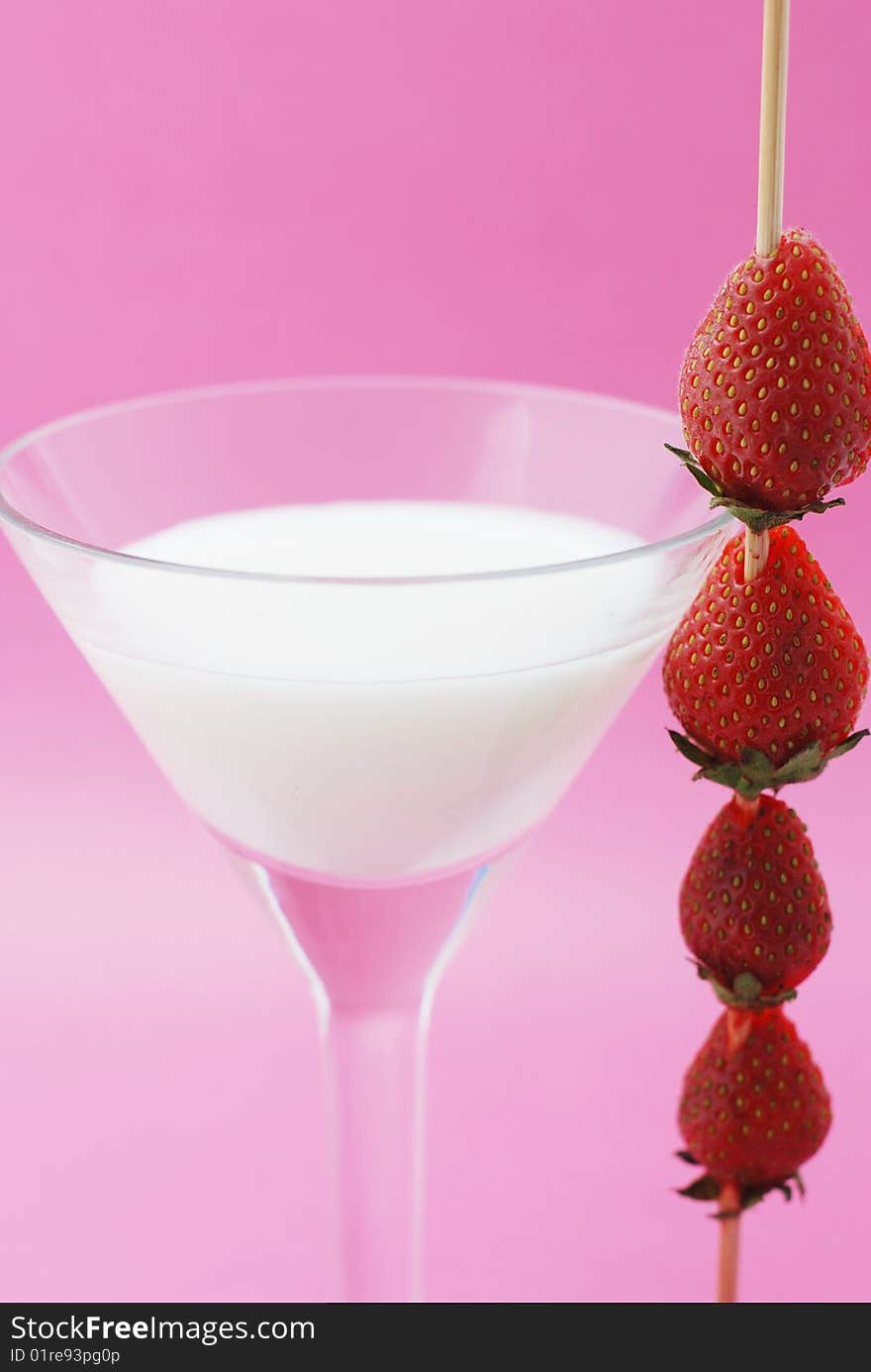 A cocktail is creamy with a strawberry