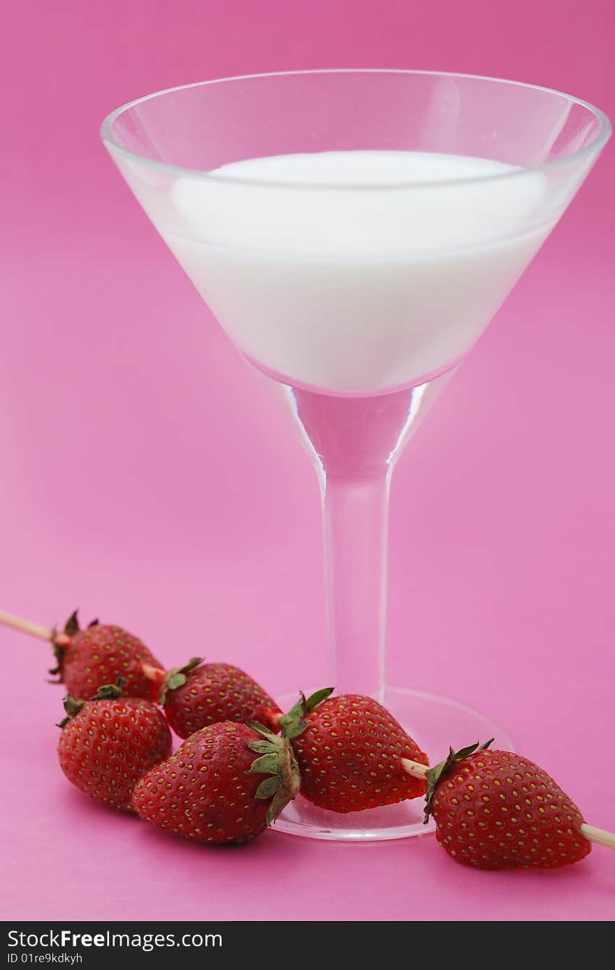 A cocktail is creamy with a strawberry