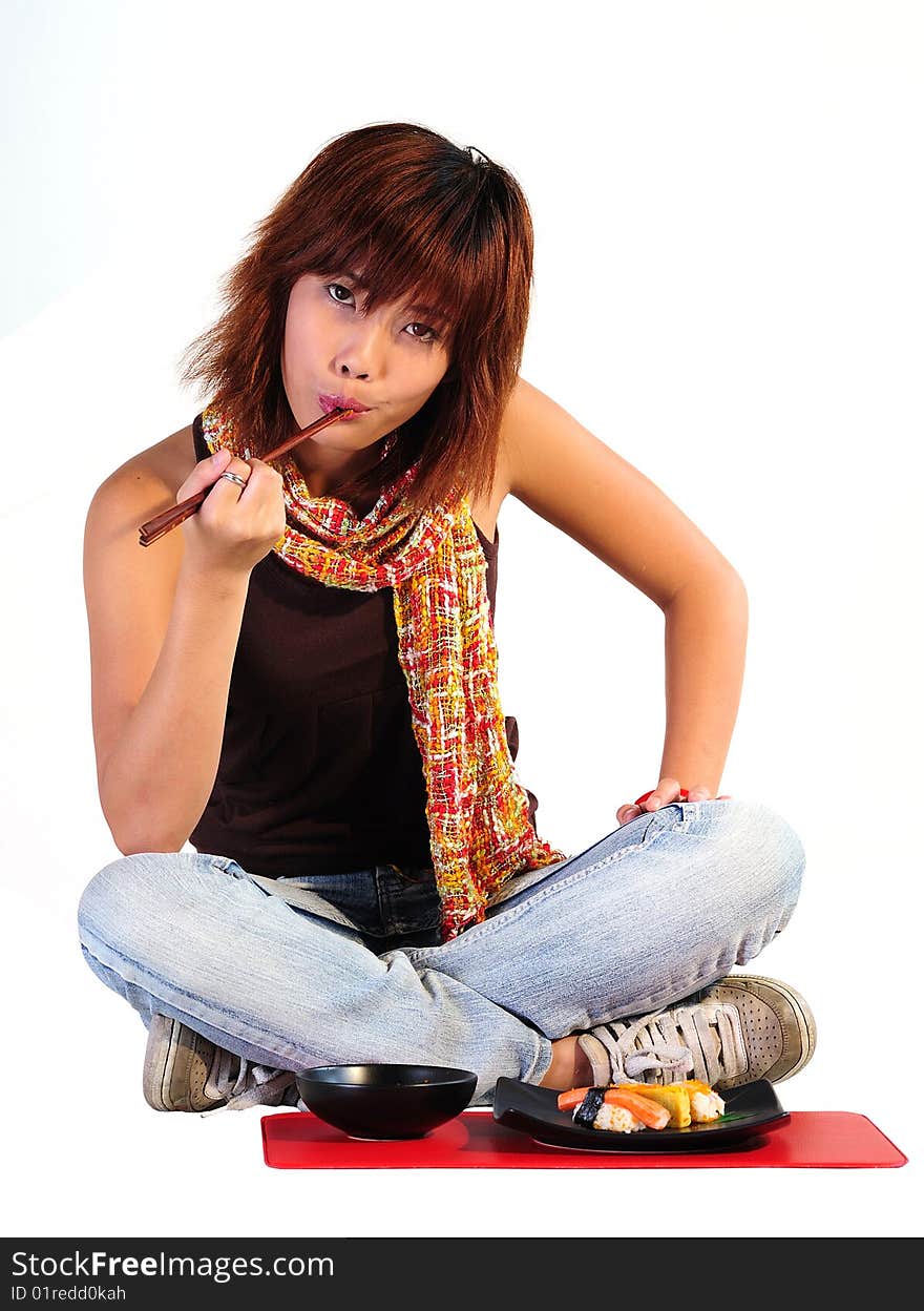 Very seductive young asian woman eating sushi on a white background