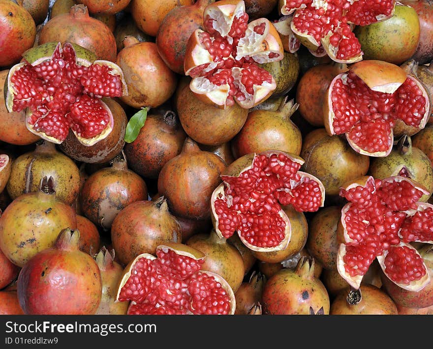 Closeup of pomegranate seeds and fruit (Punica granatum) on display in a street market