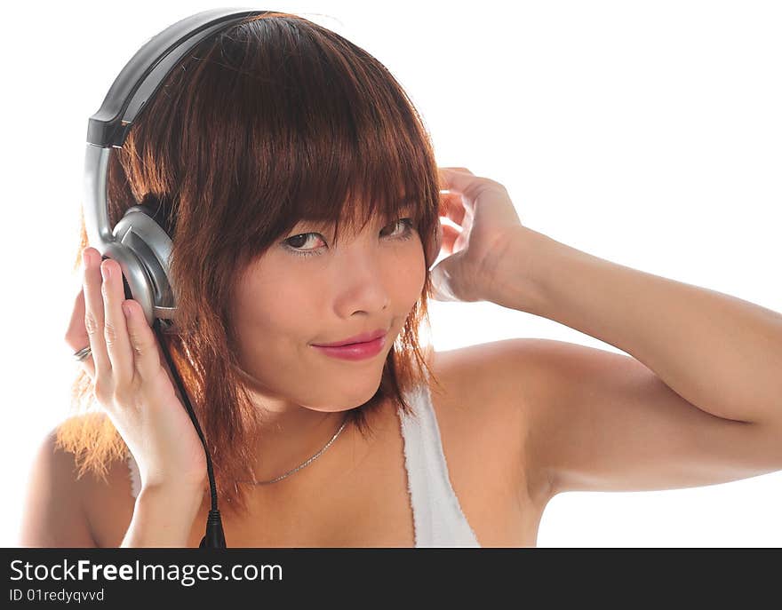 Very seductive young asian woman listening music with headphone