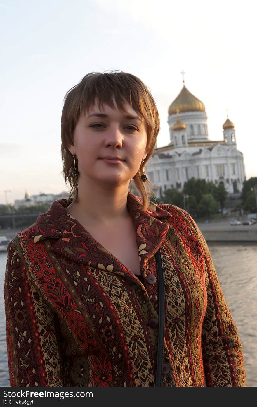 The woman poses on a church background. The woman poses on a church background