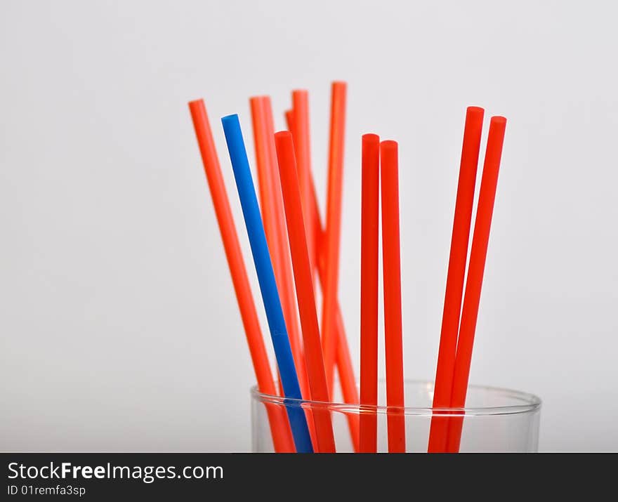 Blue straw among red straws. Blue straw among red straws