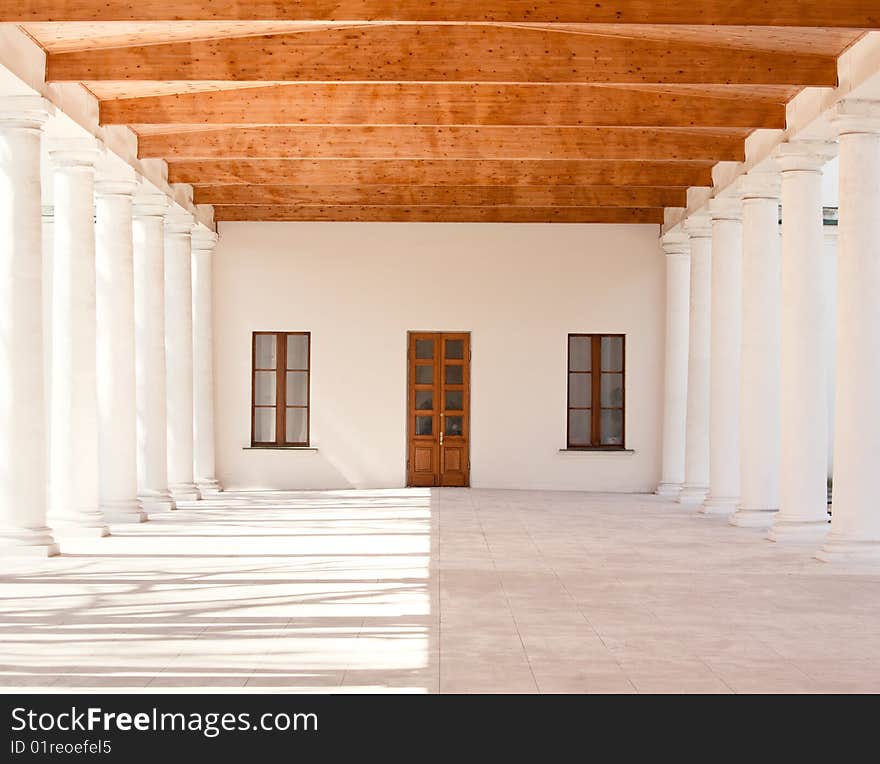 Column gallery with windows and a door