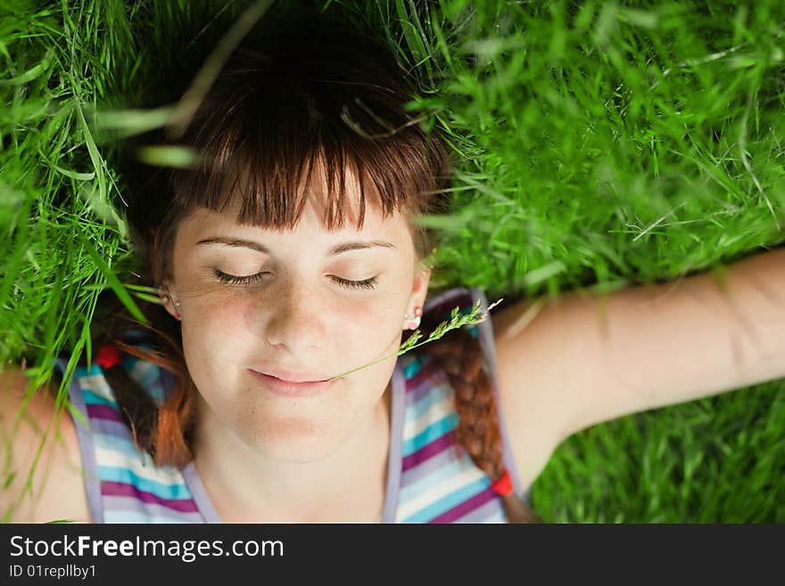 Young girl lying in the grass