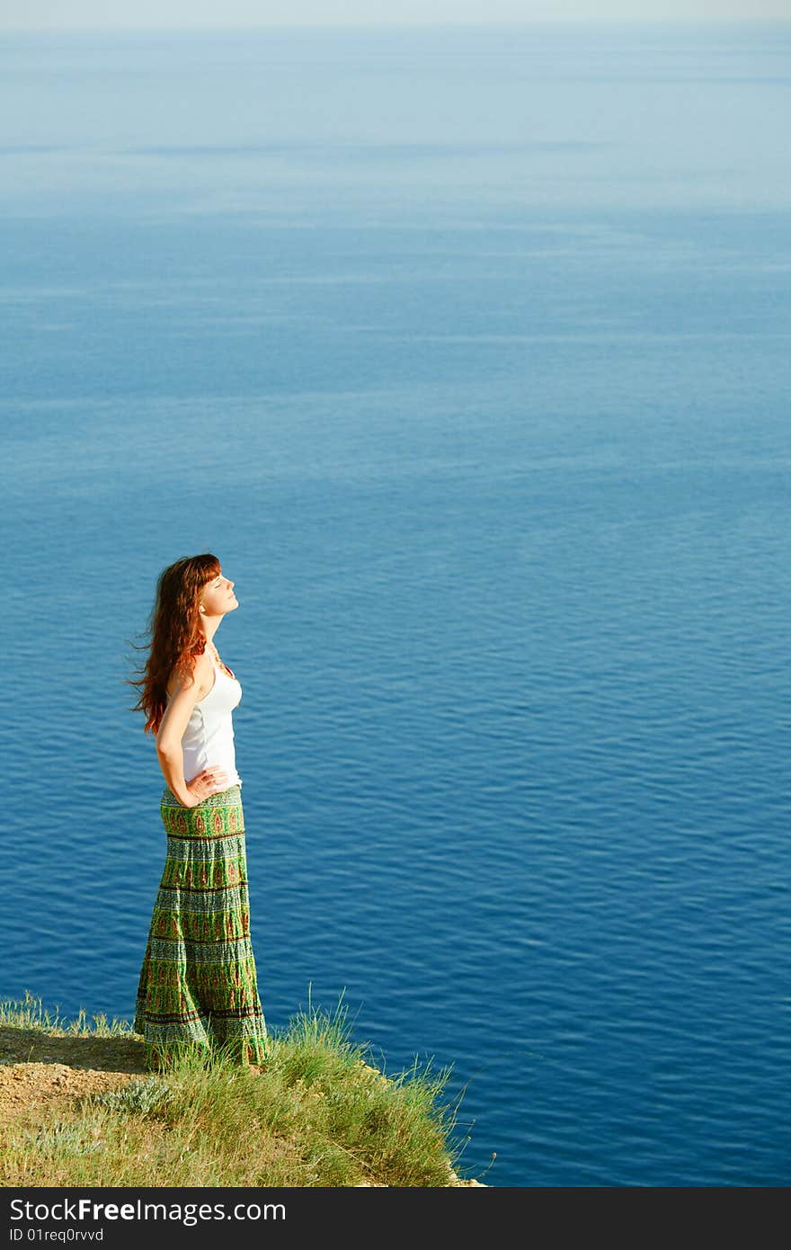 Young girl against blue sea